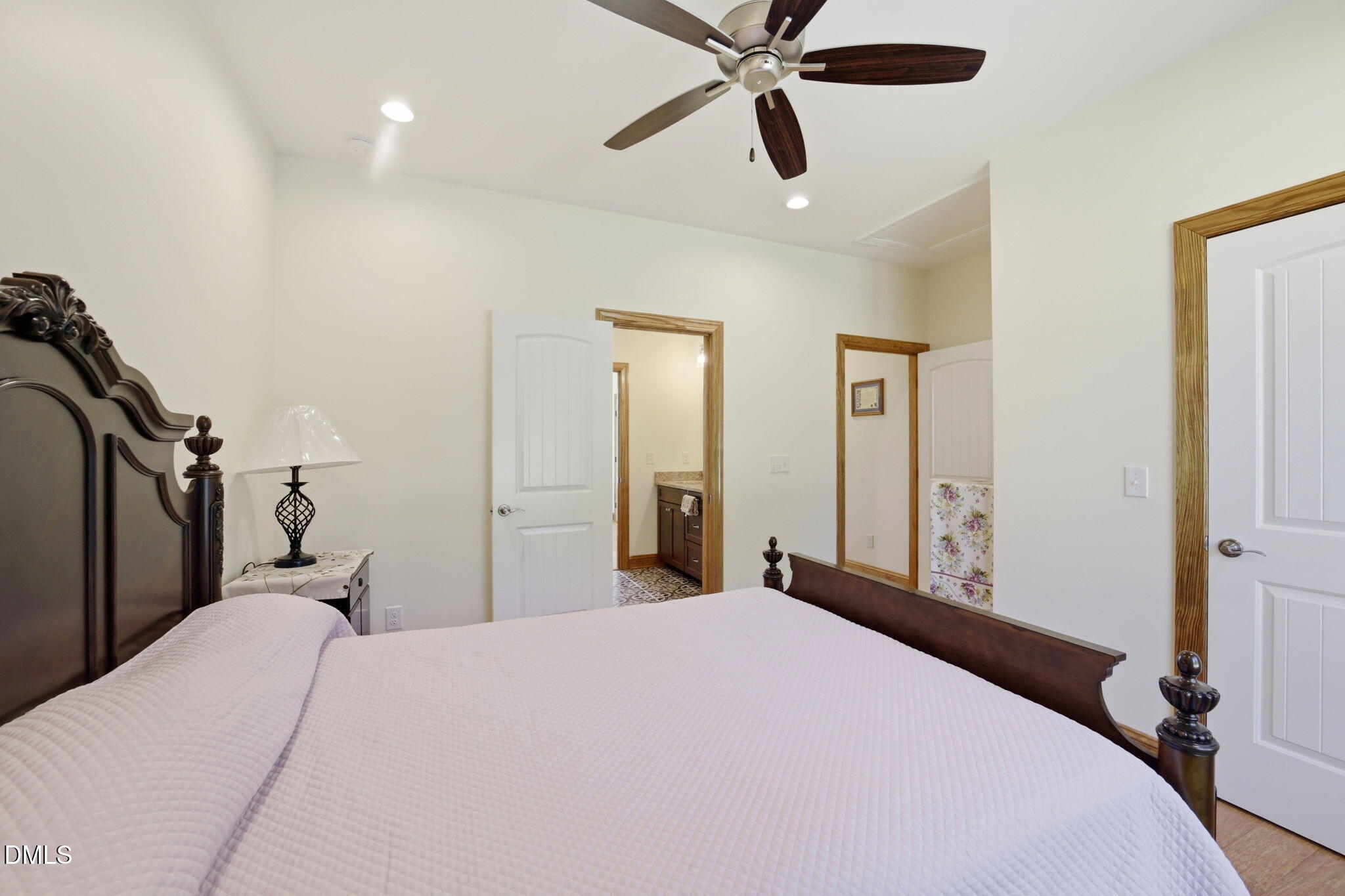 35 North Rippling Court Smithfield, NC 27577 - Photo 33 of 59 a bedroom with a bed and a chandelier