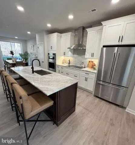 a kitchen with a refrigerator a stove a sink and a oven