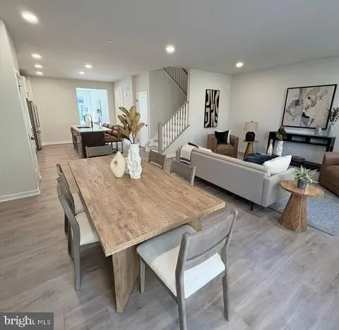 a living room with furniture wooden floor and a large window