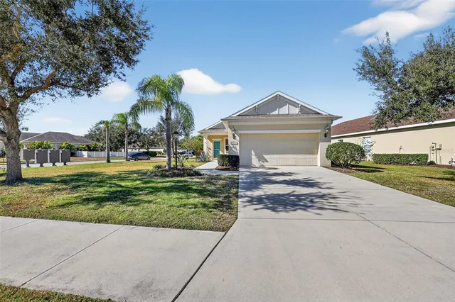 a front view of a house with a yard and a garage