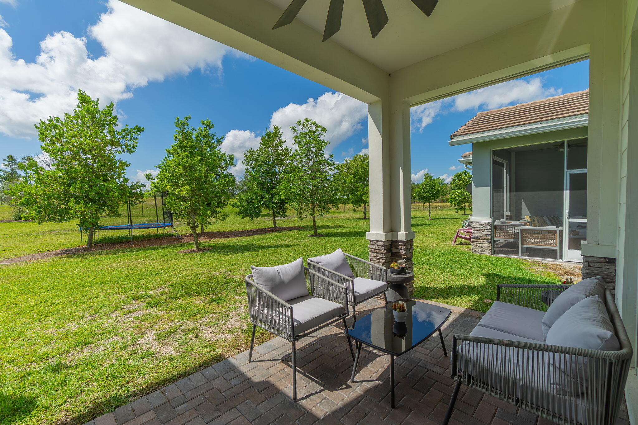 19546 Weathervane Way Loxahatchee, FL 33470 - Photo 32 of 63 a view of backyard with outdoor seating and green space