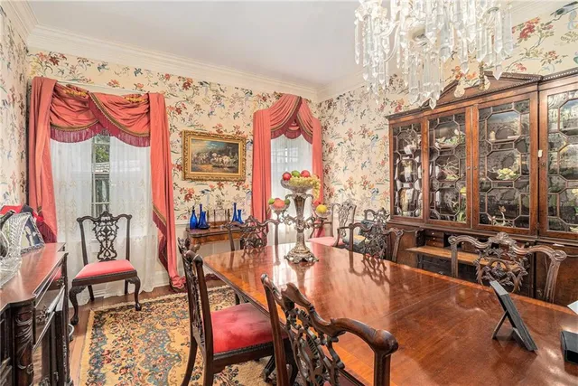 a view of a dining room with furniture water view and large windows
