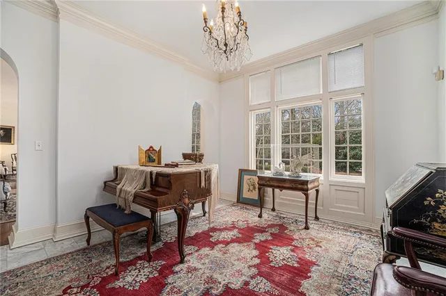 a living room with furniture a flat screen tv and a window
