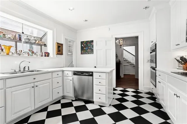 a kitchen with a checkered floor and white cabinets