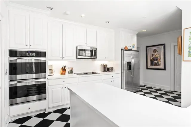 a kitchen with stainless steel appliances a refrigerator sink and stove