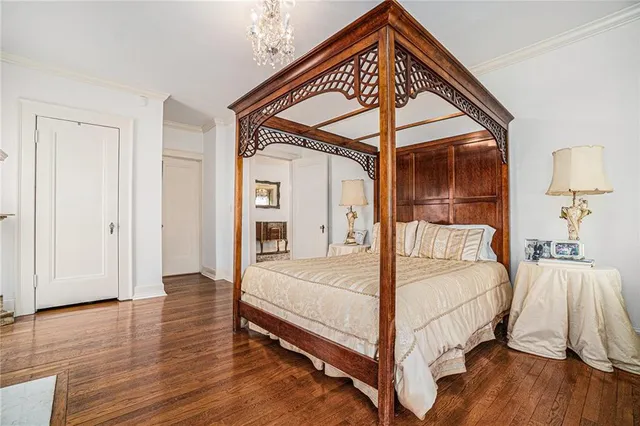 a bedroom with a bed and a mirror