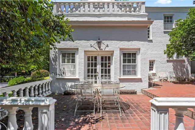 a view of a house with a small yard and wooden fence