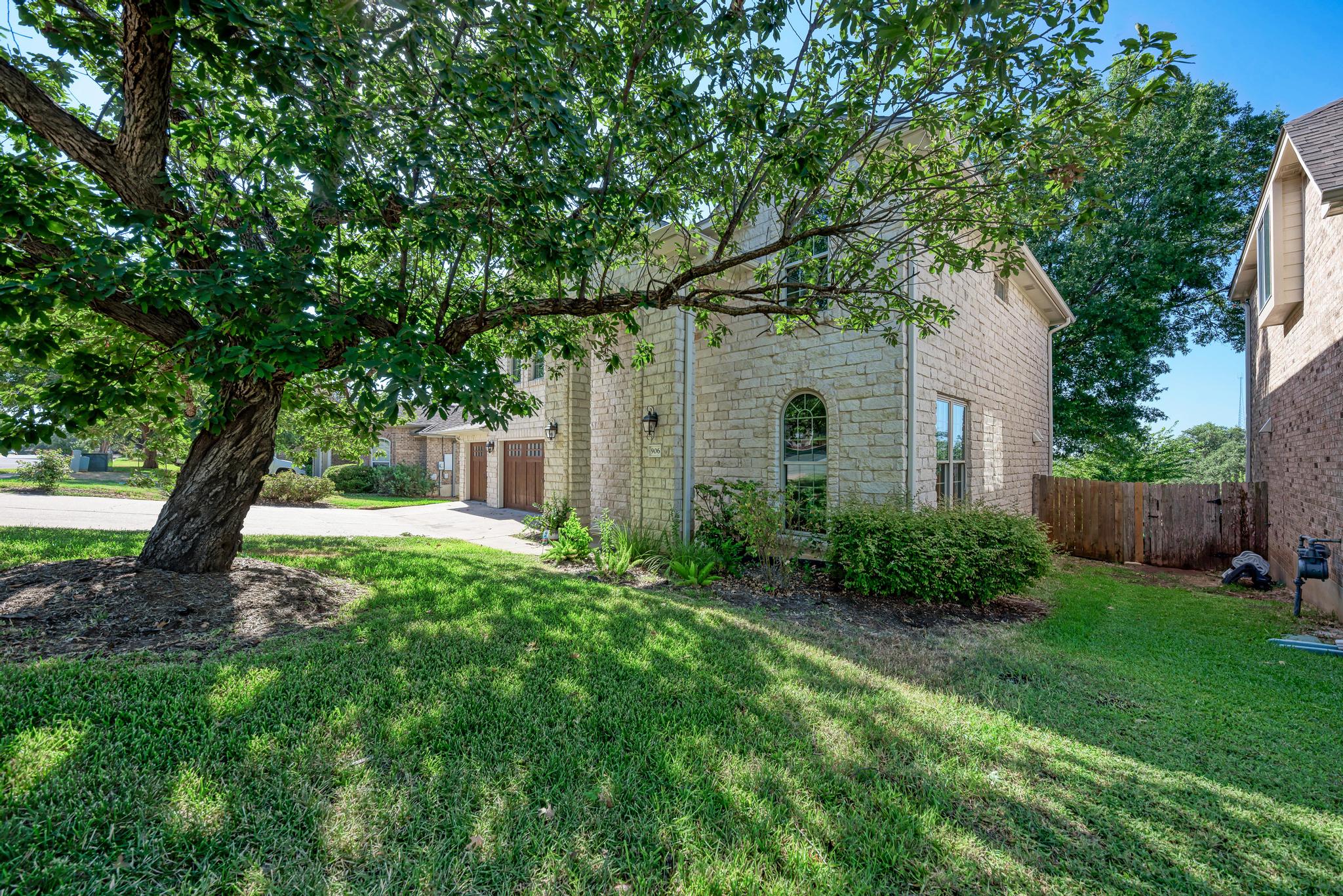 906 Antelope Ridge Cedar Park, TX 78613 - Photo 2 of 40 Textured stone siding and arched windows define this traditional exterior surrounded by mature shade trees.