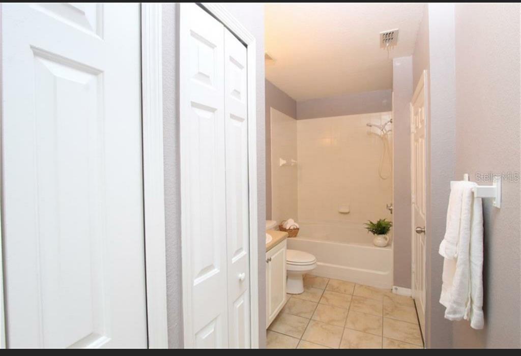 5550 East Michigan Street, Unit 3120 Orlando, FL 32822 - Photo 15 of 17 a bathroom with a granite countertop bathtub shower and toilet