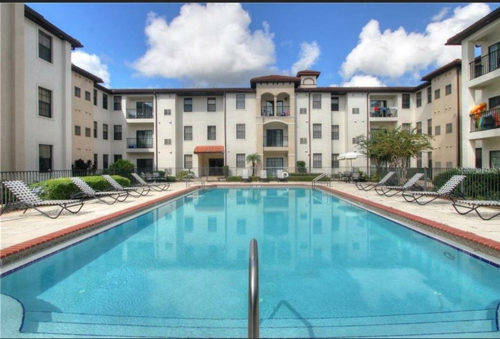 5550 East Michigan Street, Unit 3120 Orlando, FL 32822 - Photo 3 of 17 a view of a living room and kitchen