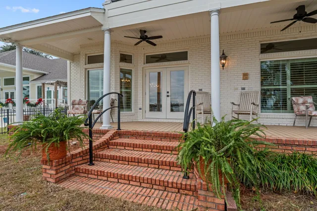 a view of a porch with a table and chairs