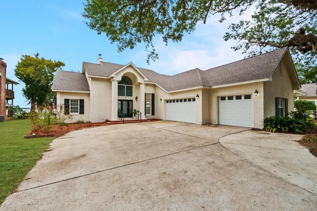a living room with furniture a rug and a chandelier