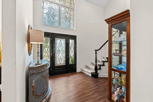 a bedroom with a large bed and a large mirror on a dresser