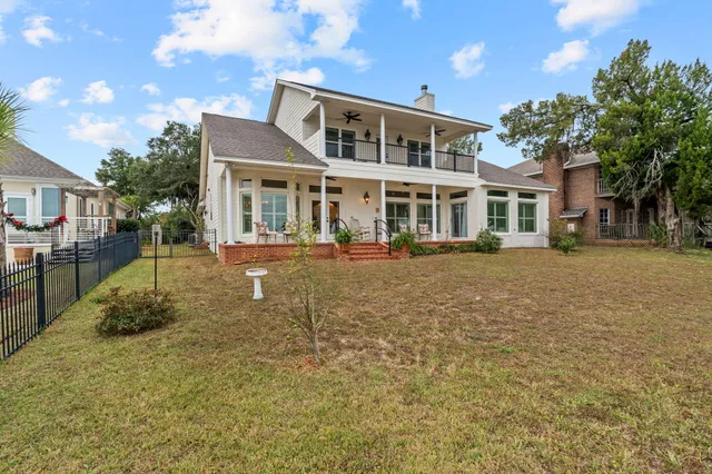 a living room with patio furniture and garden view