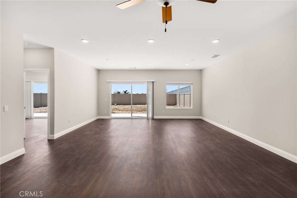 1243 Ansley Lane Mentone, CA 92359 - Photo 12 of 24 a view of a livingroom with wooden floor and window