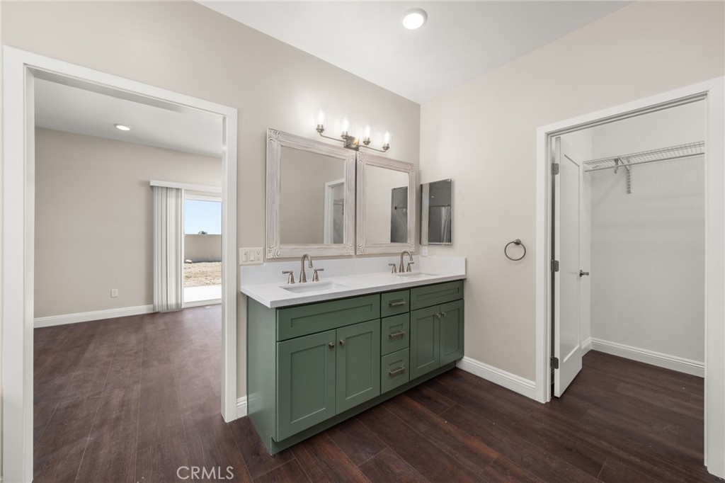1243 Ansley Lane Mentone, CA 92359 - Photo 14 of 24 a bathroom with a double vanity sink and mirror