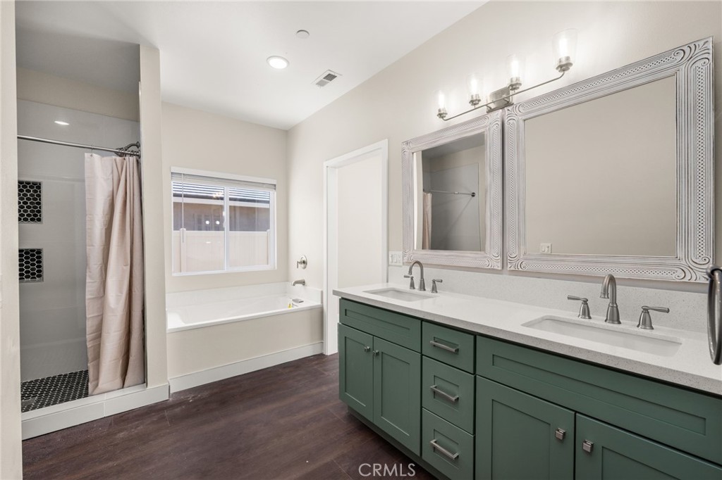 1243 Ansley Lane Mentone, CA 92359 - Photo 15 of 24 a bathroom with a tub sink double vanity and a mirror