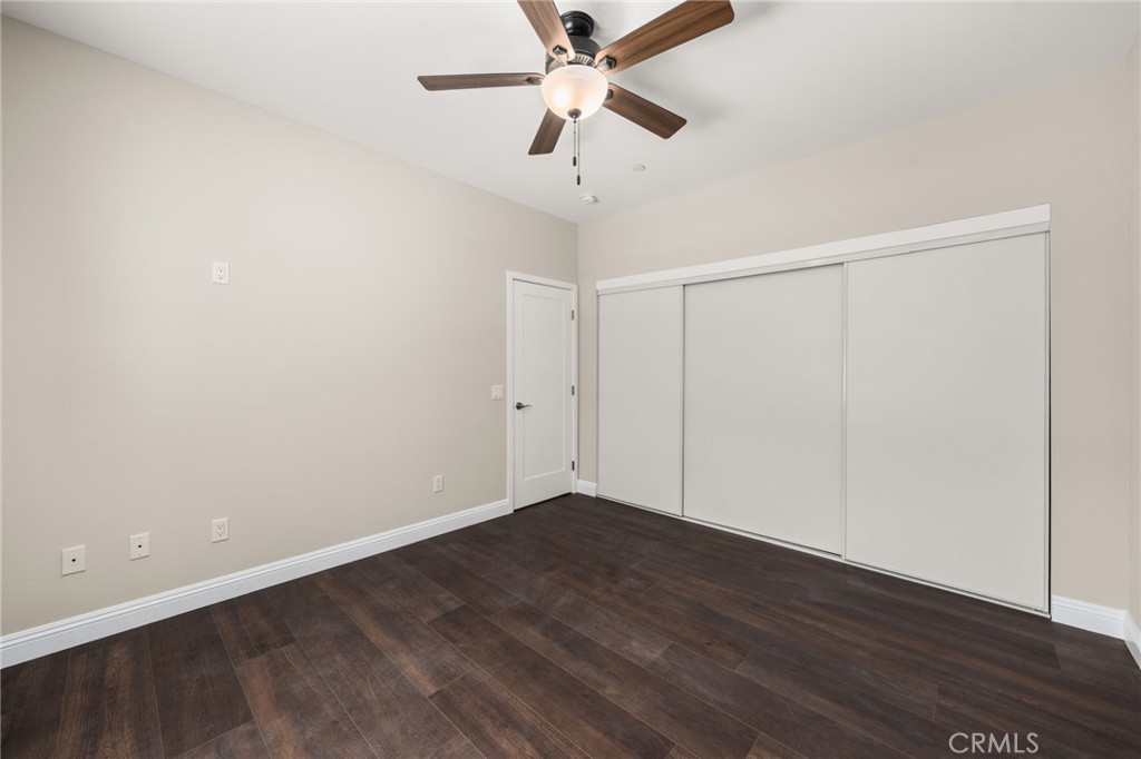 1243 Ansley Lane Mentone, CA 92359 - Photo 18 of 24 a view of an empty room with wooden floor