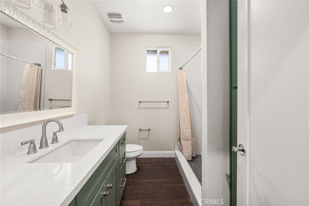 1243 Ansley Lane Mentone, CA 92359 - Photo 19 of 24 a bathroom with a sink a toilet and a mirror