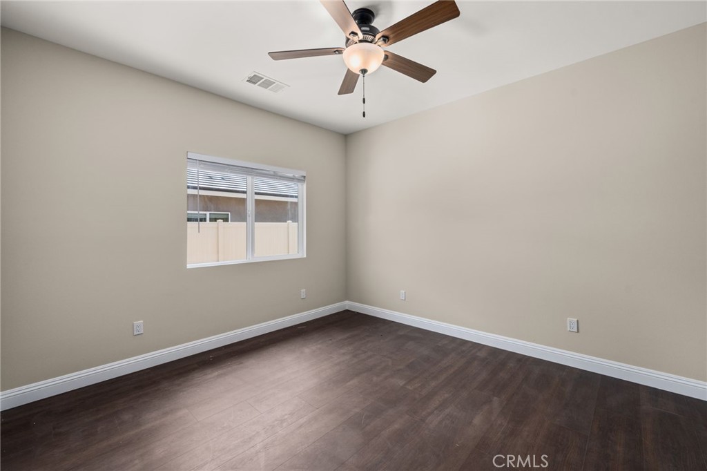 1243 Ansley Lane Mentone, CA 92359 - Photo 20 of 24 an empty room with a window and a ceiling fan