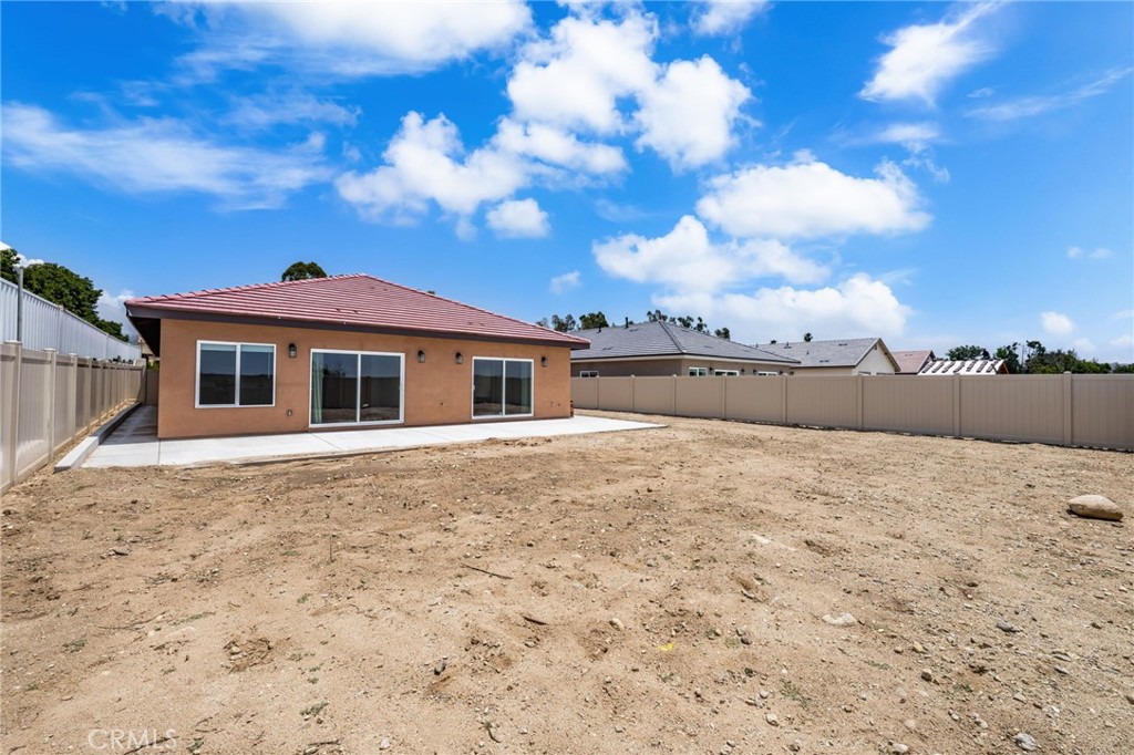 1243 Ansley Lane Mentone, CA 92359 - Photo 22 of 24 a big house with a big yard and large trees