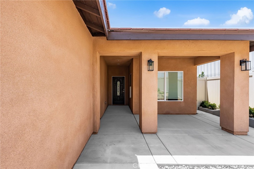 1243 Ansley Lane Mentone, CA 92359 - Photo 3 of 24 a view of a hallway with wooden shelves