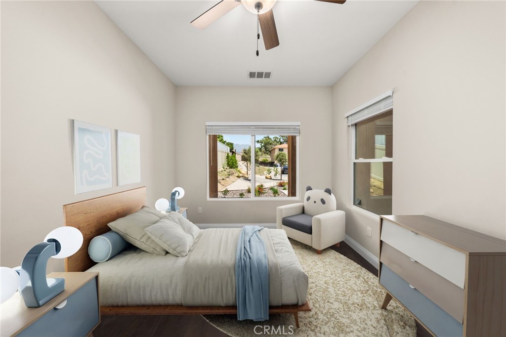 1243 Ansley Lane Mentone, CA 92359 - Photo 10 of 24 a bedroom with a bed couch and window