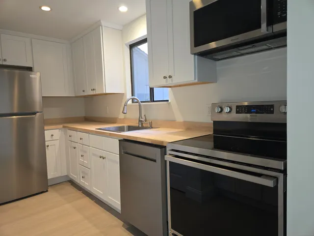 a kitchen with a sink stove and refrigerator