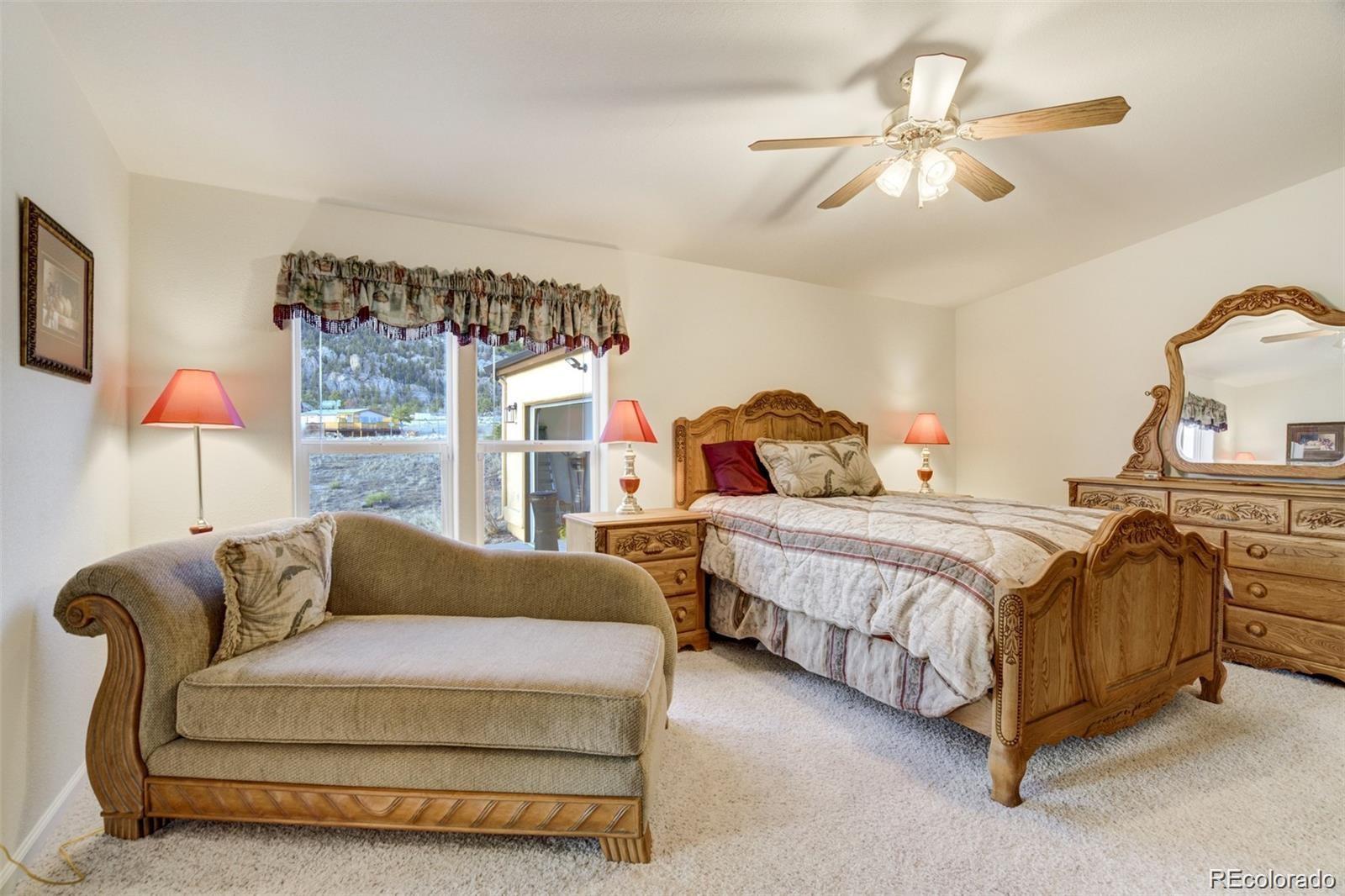 688 Tiara Road Lake George, CO 80827 - Photo 14 of 46 a bedroom with a bed couch and window