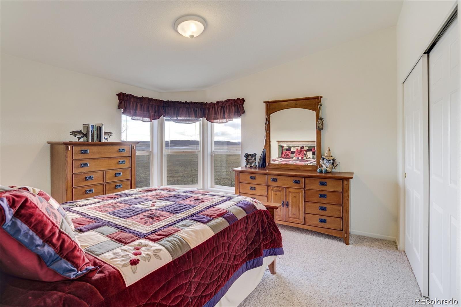 688 Tiara Road Lake George, CO 80827 - Photo 18 of 46 a bedroom with a bed and a dresser
