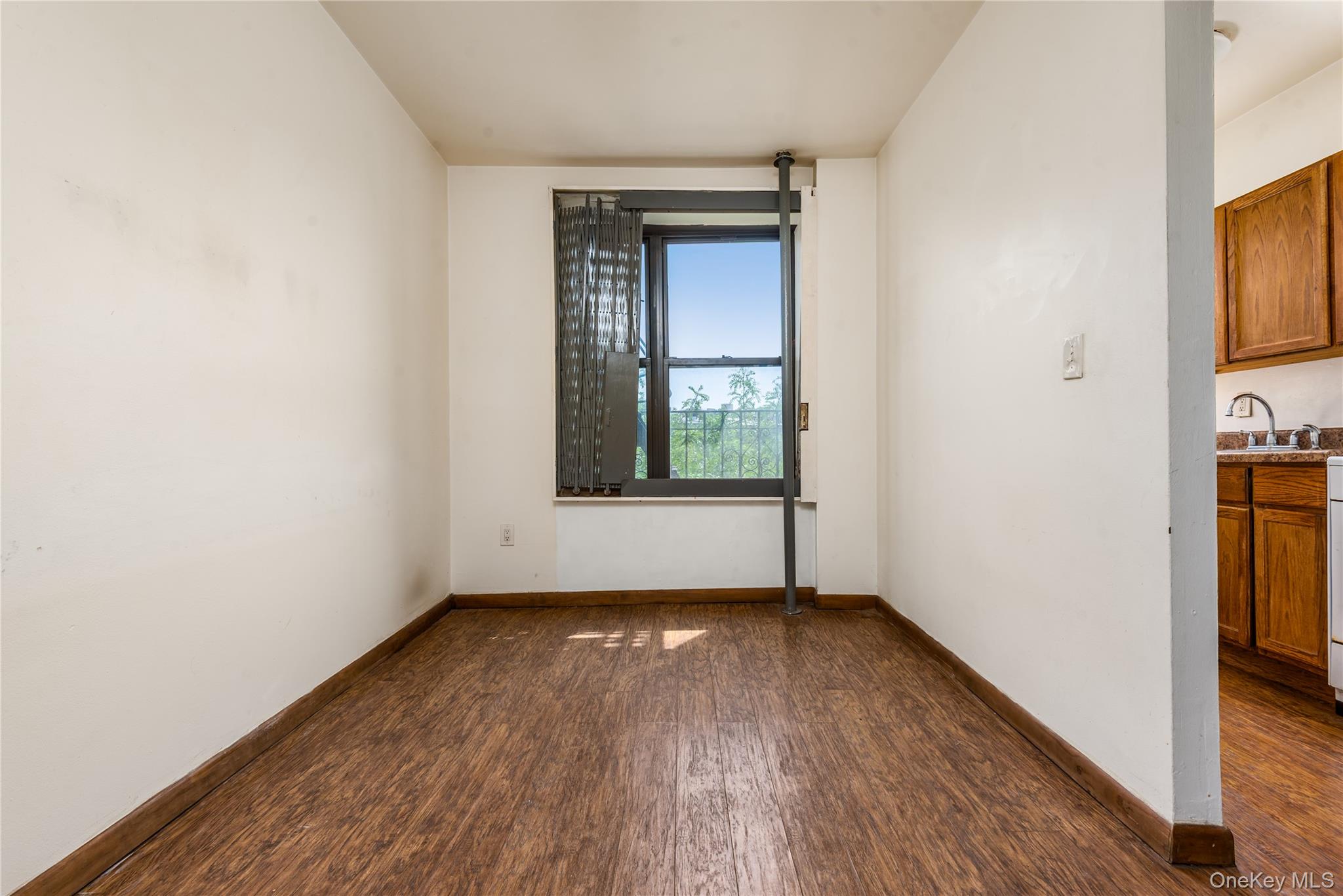 95 South 10th Street, Unit 22 Brooklyn, NY 11249 - Photo 3 of 8 Unfurnished room with dark wood-style floors and baseboards