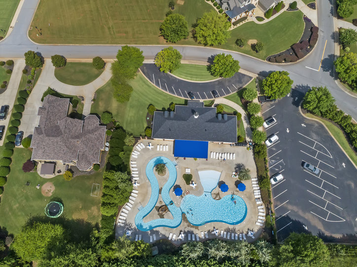 121 Loudwater Drive Anderson, SC 29621 - Photo 2 of 3 This aerial view showcases a vibrant community pool area and convenient parking facilities.