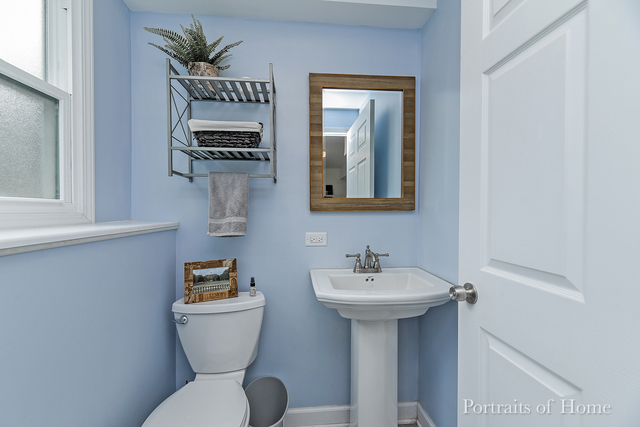 346 Rockhurst Road Bolingbrook, IL 60440 - Photo 18 of 19 a bathroom with a toilet sink and mirror