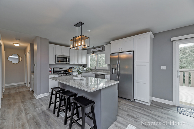 346 Rockhurst Road Bolingbrook, IL 60440 - Photo 9 of 19 a kitchen with stainless steel appliances granite countertop a sink a stove and refrigerator