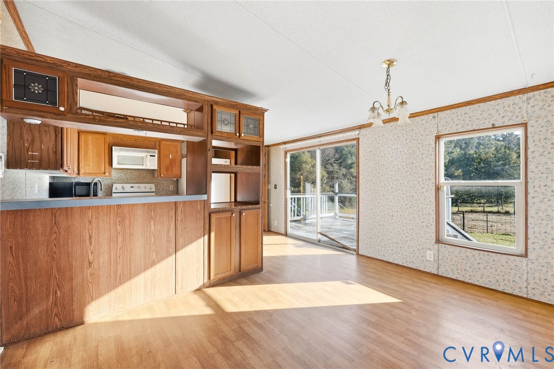 7410 Richmond Road Amelia Court House, VA 23002 - Photo 11 of 39 a living room with stainless steel appliances wooden floor and large windows