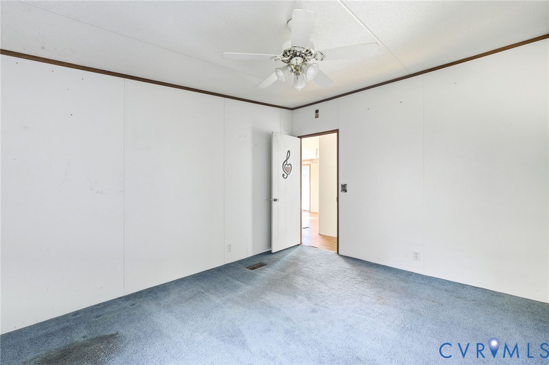 7410 Richmond Road Amelia Court House, VA 23002 - Photo 18 of 39 a view of a hallway with a chandelier fan