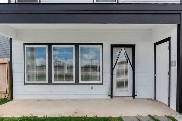 a view of a house with a big yard and large trees