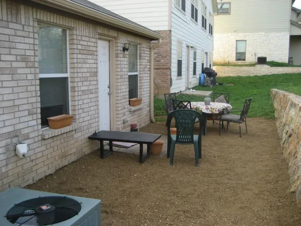 a house view with a garden space and outdoor seating