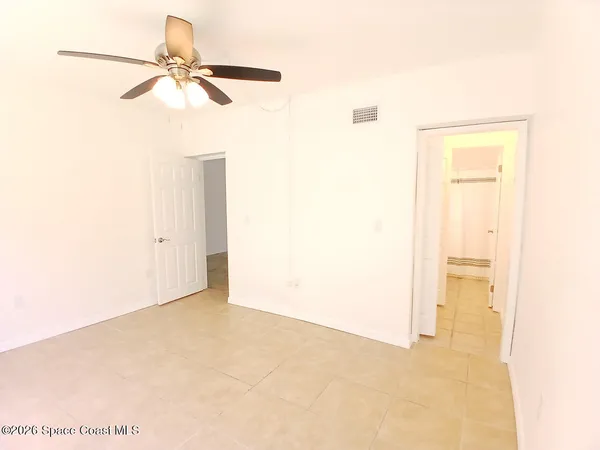a view of a room with a ceiling fan