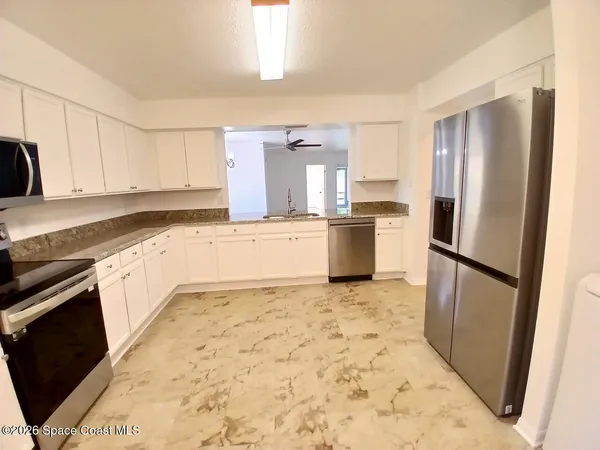 a kitchen with a refrigerator sink and stove