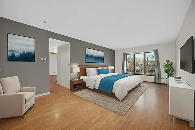 a bedroom with a large bed and a couch