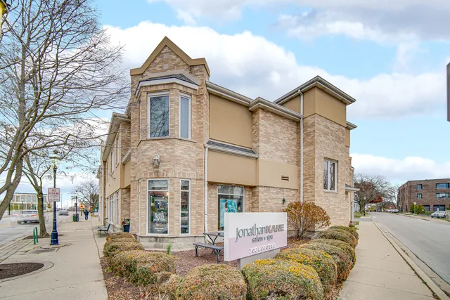 a front view of a residential apartment building with a yard