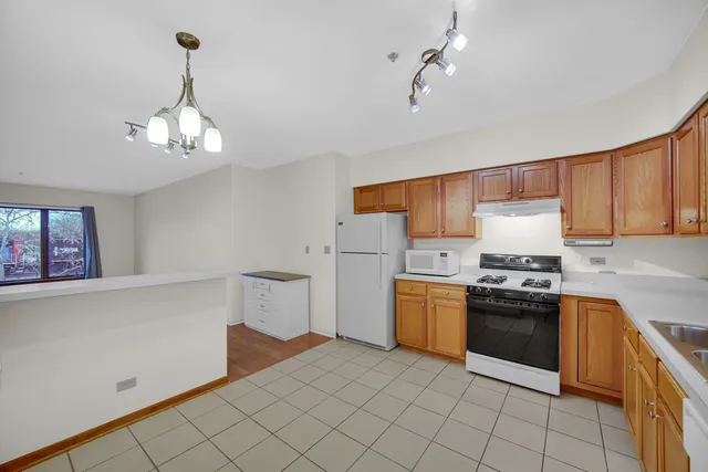a kitchen with a stove top oven cabinets and a sink