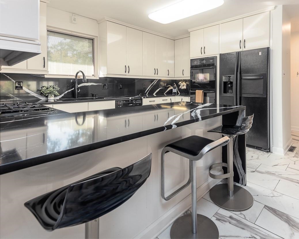 110 Wallace Road Memphis, TN 38117 - Photo 5 of 25 a kitchen with stainless steel appliances granite countertop a sink a stove and a refrigerator