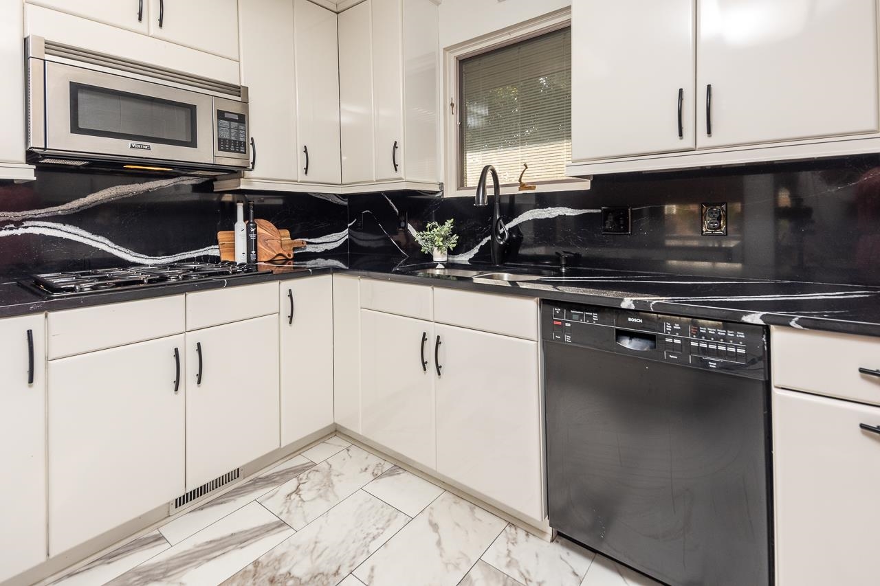 110 Wallace Road Memphis, TN 38117 - Photo 6 of 25 a kitchen with granite countertop a sink dishwasher a stove and a microwave oven with cabinets