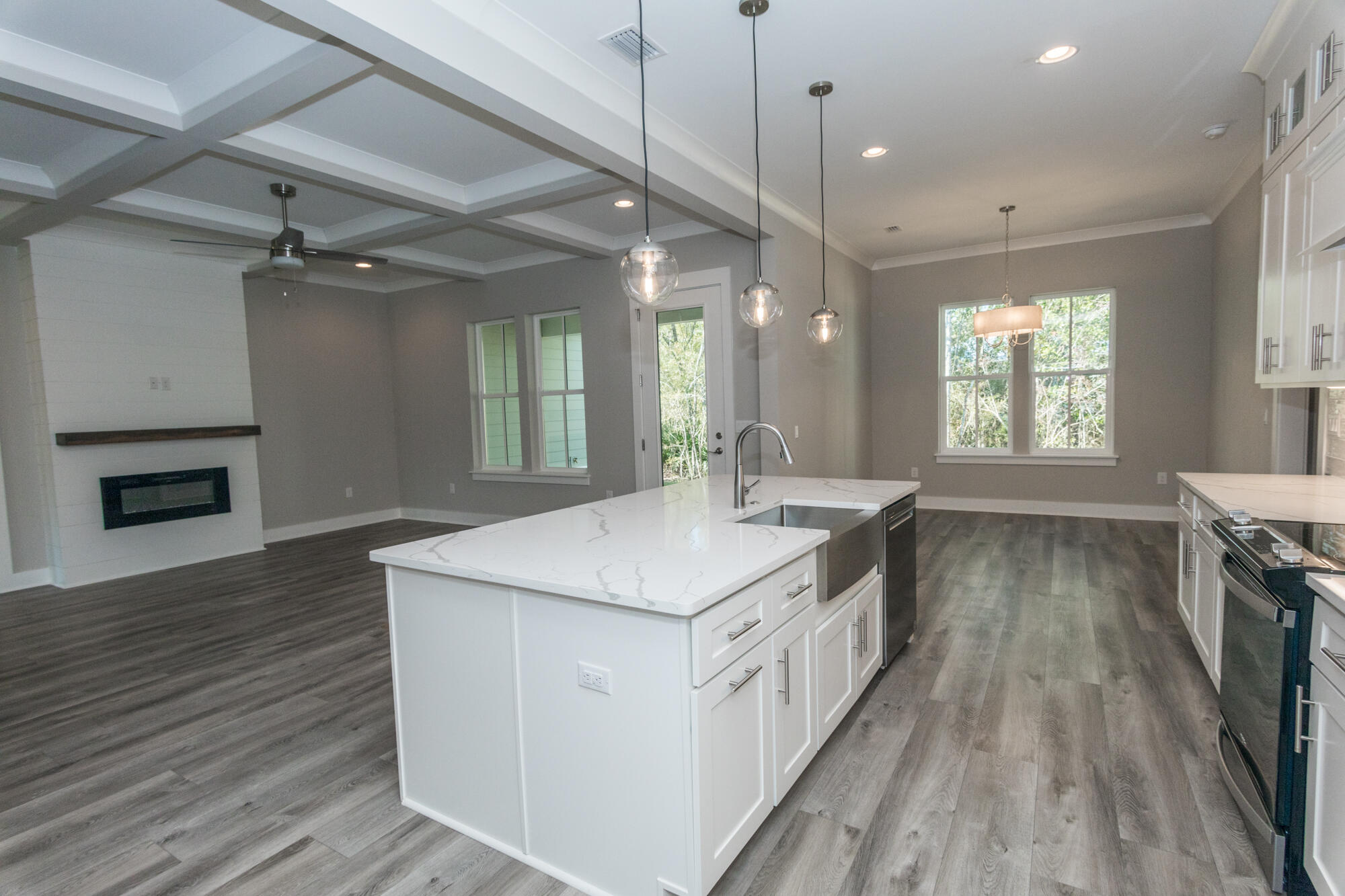 190 Bear Creek Boulevard Freeport, FL 32439 - Photo 12 of 85 a kitchen with counter top space a sink wooden floor and windows
