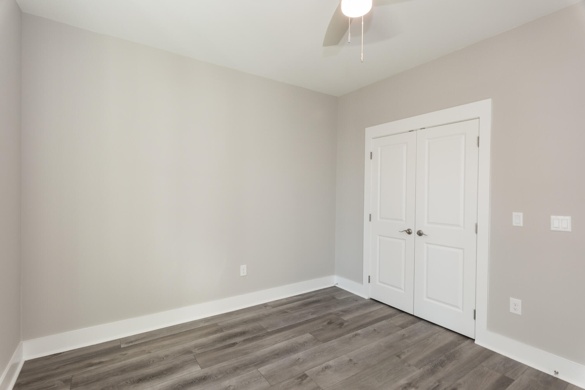 190 Bear Creek Boulevard Freeport, FL 32439 - Photo 41 of 85 a view of an empty room with wooden floor a chandelier fan and closet area