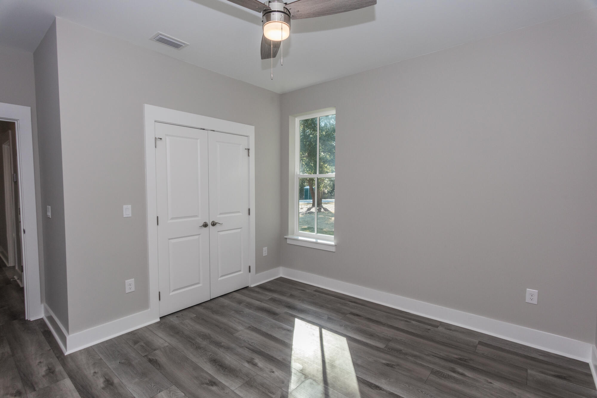 190 Bear Creek Boulevard Freeport, FL 32439 - Photo 45 of 85 an empty room with wooden floor and windows