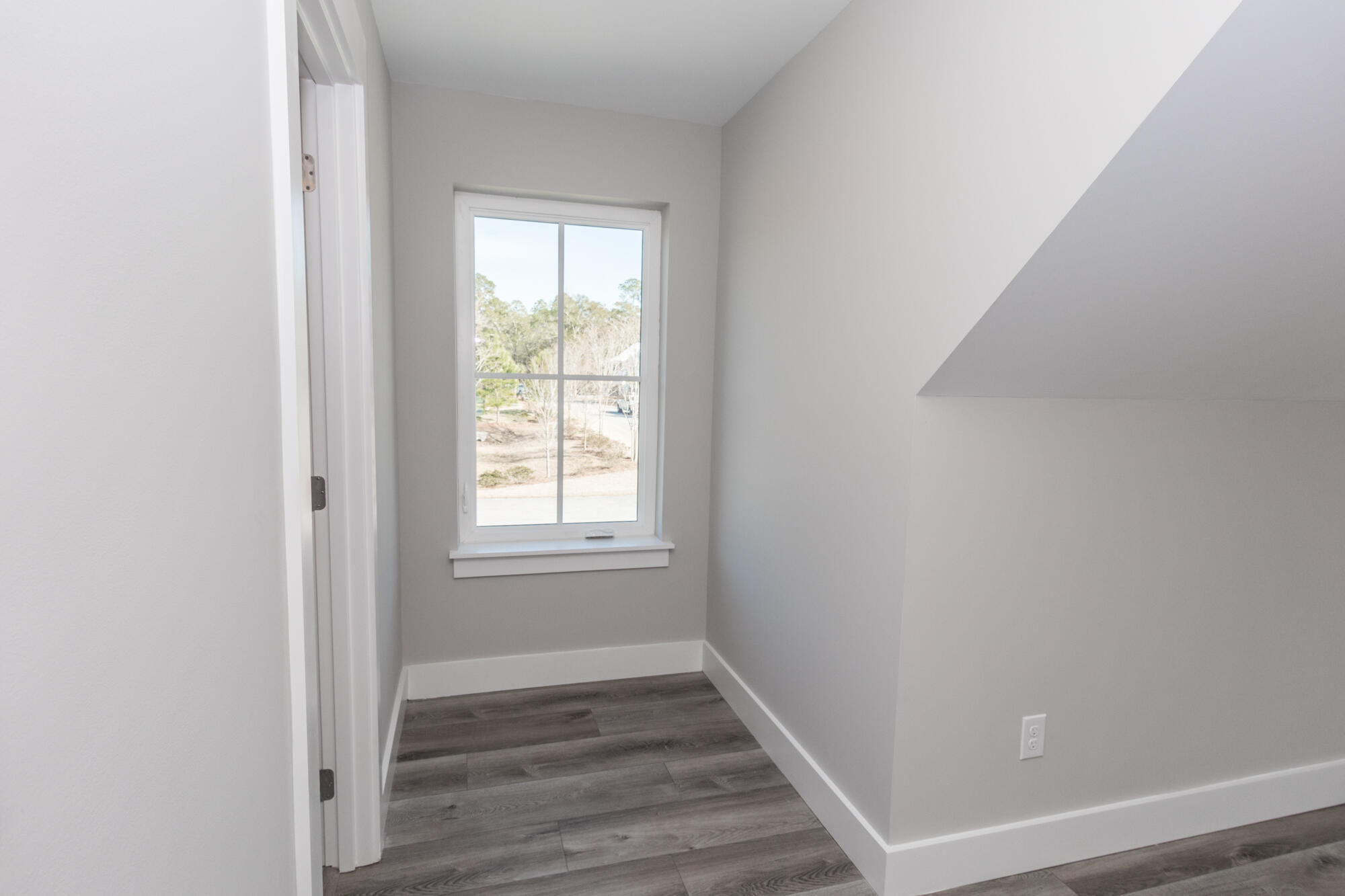 190 Bear Creek Boulevard Freeport, FL 32439 - Photo 51 of 85 an empty room with wooden floor and windows