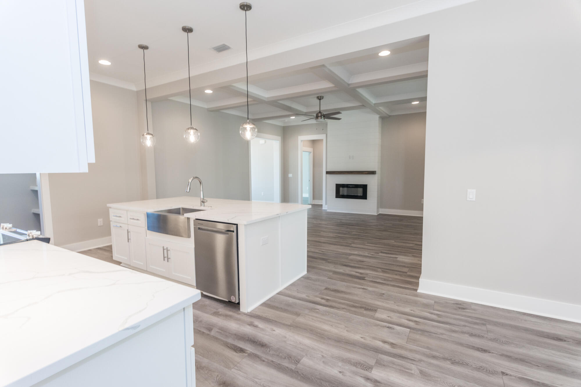 190 Bear Creek Boulevard Freeport, FL 32439 - Photo 54 of 85 a large white kitchen with a stove a sink dishwasher and a refrigerator with wooden floor